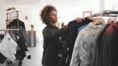 Store manager using digital tablet in a clothing store