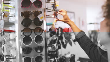 Close-up of young adult shopping for sunglasses