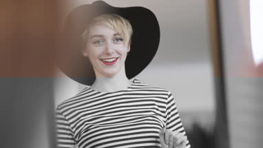 Young adult female trying on clothes in a vintage store