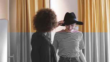 Young adult female trying on clothes in a vintage store