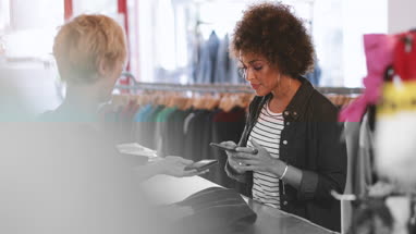 Customer paying for clothes at checkout