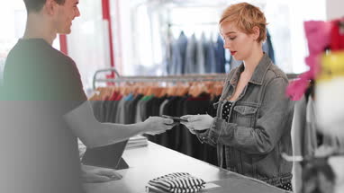 Customer paying for clothes at checkout