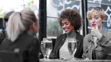 Friends drinking in an outdoor bar in summer