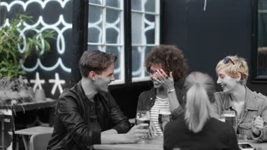 Friends drinking in an outdoor bar in summer