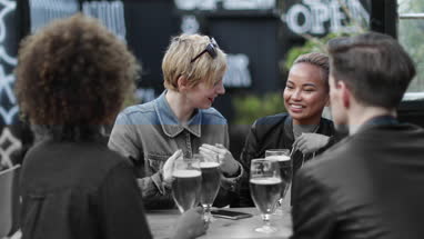 Friends drinking in an outdoor bar in summer