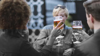 Friends drinking in an outdoor bar in summer