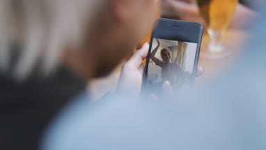 Young adult looking at photos on a smartphone