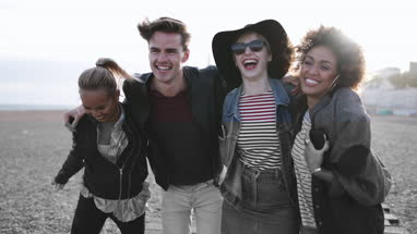 Friends on the beach in evening light