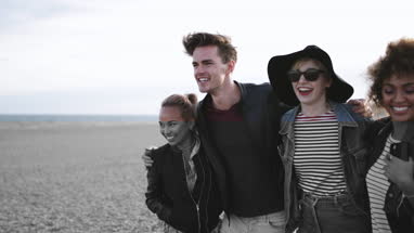 Friends on the beach in evening light