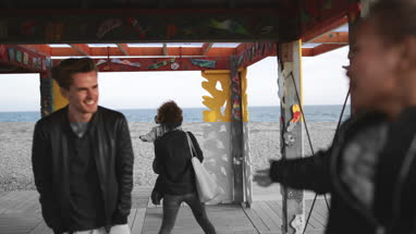 Friends taking a group selfie on the beach