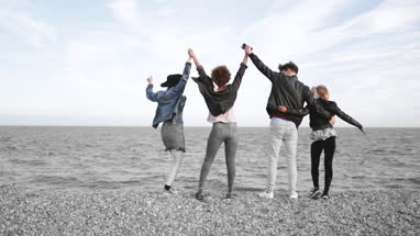 Friends on the beach in evening light