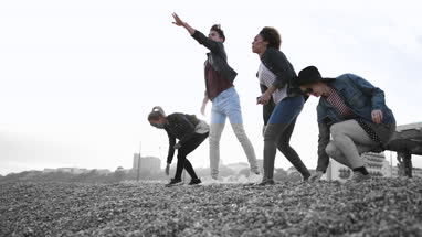 Friends on the beach in evening light