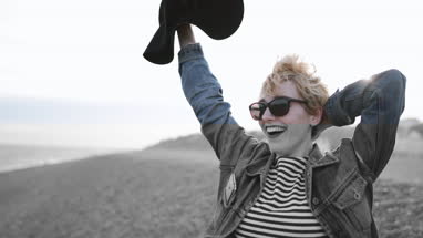 Carefree millennial on a beach in evening light
