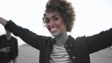 Carefree millennials on a beach in evening light