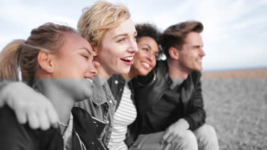 Friends on the beach in evening light