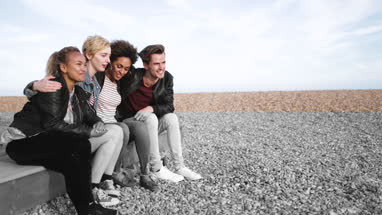 Friends on the beach in evening light