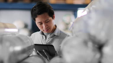 Male working in distribution warehouse with digital tablet