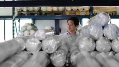 Manager checking stock in a distribution warehouse