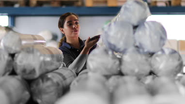 Female scanning item in distribution warehouse