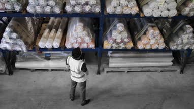 Male working in distribution warehouse with digital tablet