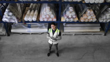 Male working in distribution warehouse with digital tablet