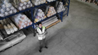 Male working in distribution warehouse with digital tablet