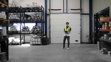 Portrait of male working in distribution warehouse with digital tablet