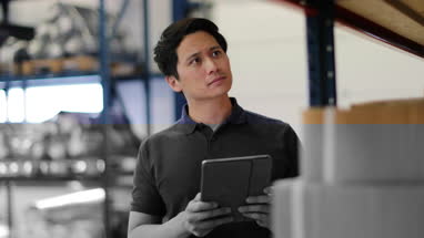 Male working in distribution warehouse with digital tablet
