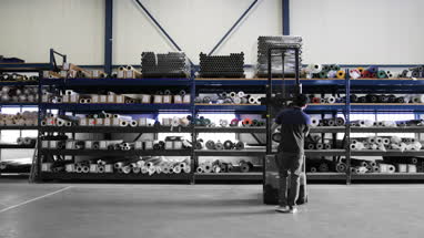 Male working in warehouse using forklift truck