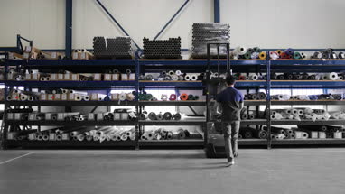 Male working in warehouse using forklift truck