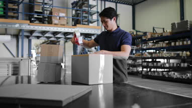 Male working in packing warehouse