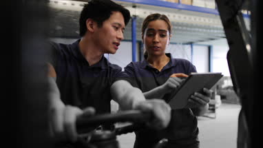 Workers in a warehouse discussing order preparation