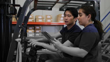 Workers in a warehouse discussing order preparation
