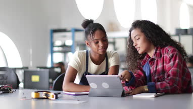 High school students working on robotics in class