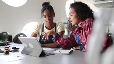 High school students working on robotics in class