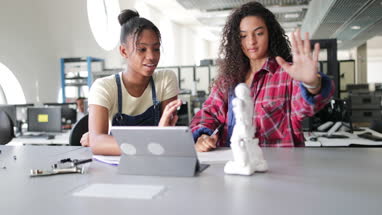 High school students working on robotics in class