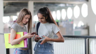 Students looking at smartphones at break time