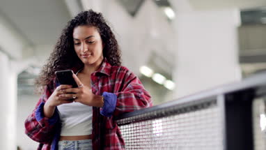 Female student looking at smartphone in high school