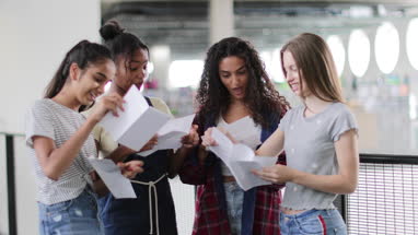 High school female students opening their exam results