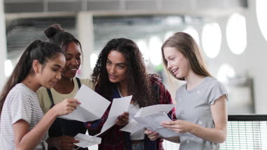 High school female students opening their exam results