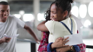 High school students opening their exam results