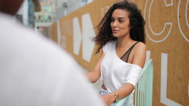 Teenagers socialising outdoors in city with smartphone