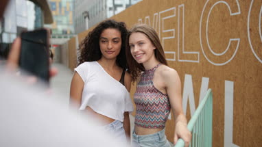 Teenagers posing for a smartphone photo 