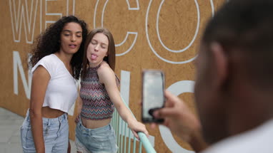 Teenagers posing for a smartphone photo 