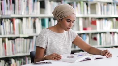 Muslim female student in college library