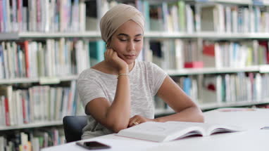 Muslim female student in college library