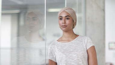 Reflection of Muslim businesswoman in an office