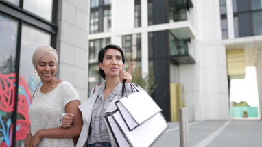 Muslim friends shopping together outdoors