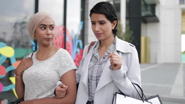 Muslim friends shopping together outdoors