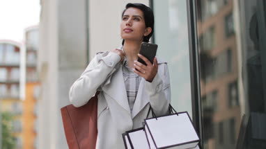 Arabic woman using a smartphone on a shopping trip